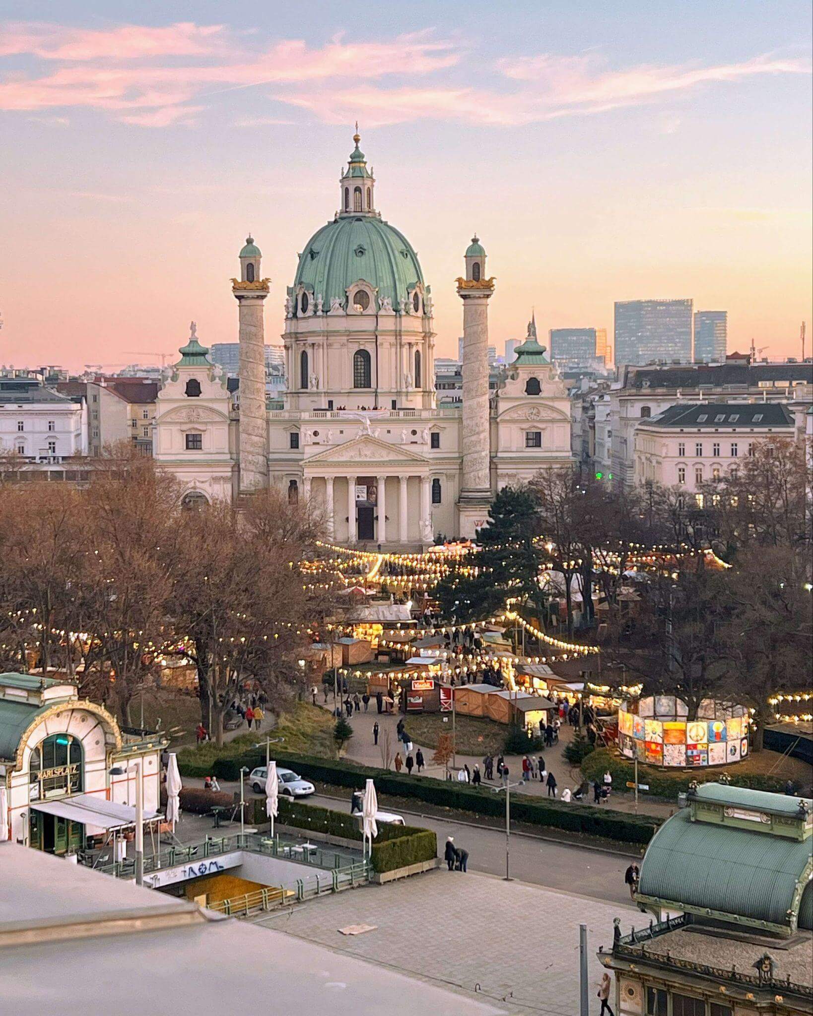 beautiful view of karls church and christmas markets in vienna at sunset, taken from carefully chosen accommodation in a central location