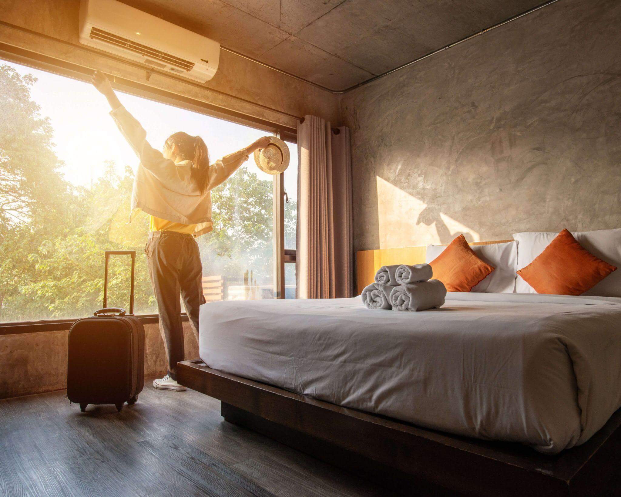 joyous arrival in a hotel room with an amazing view to the garden outside and clean, freshly made bed