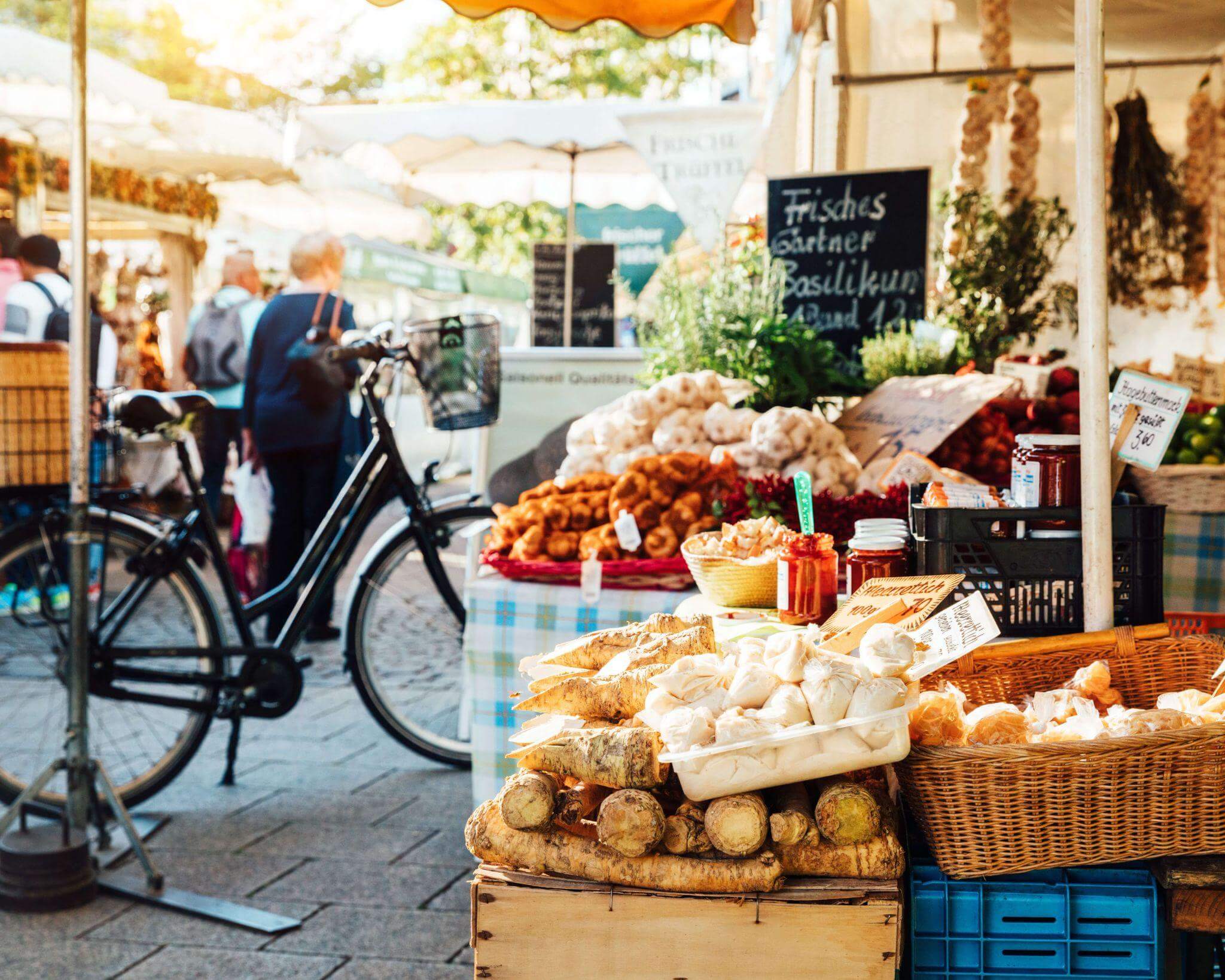 local german fresh produce market with a bicycle in the foreground, a great way to explore a village from your accommodation