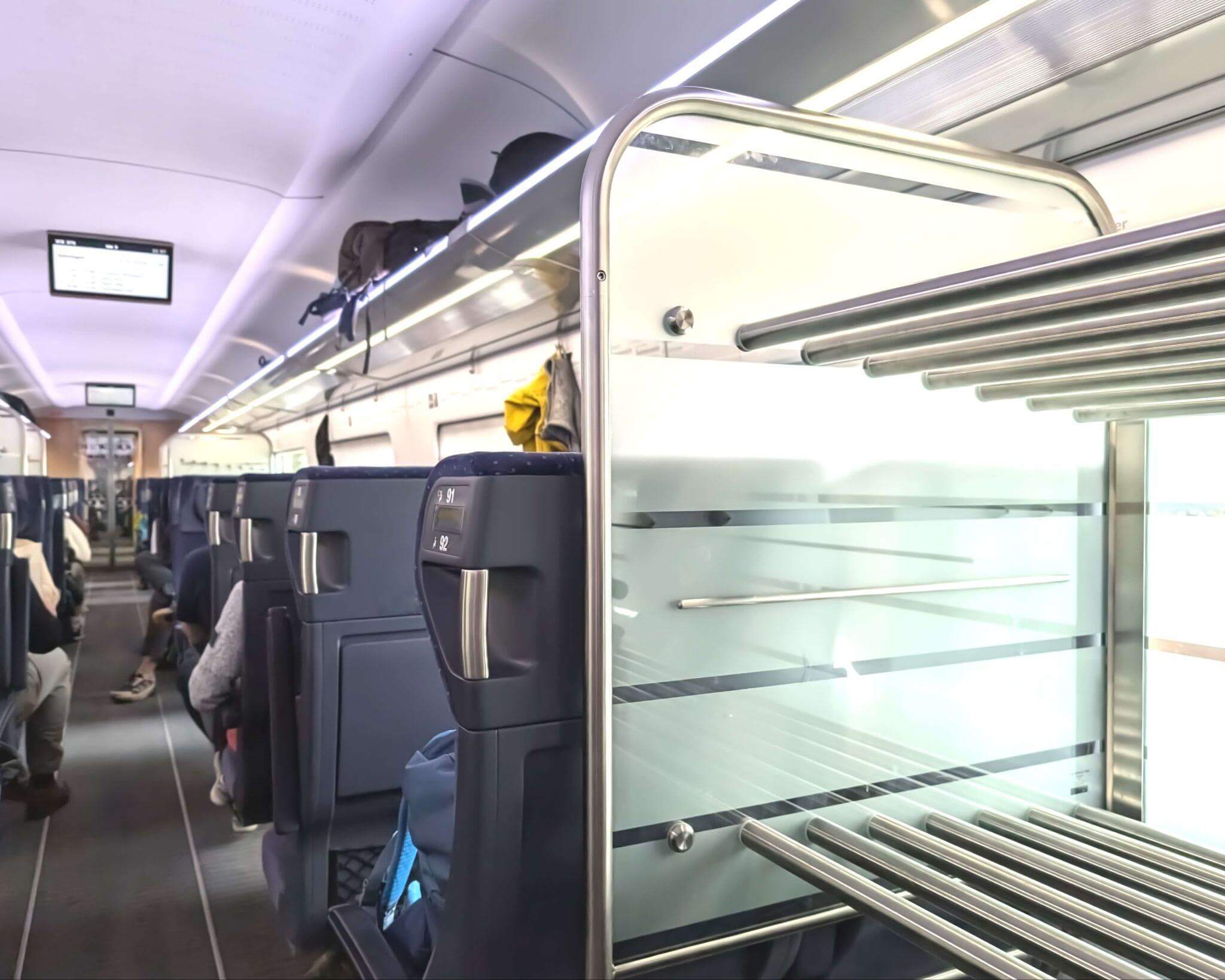 luggage racks in a train overhead and at the end of the carriage