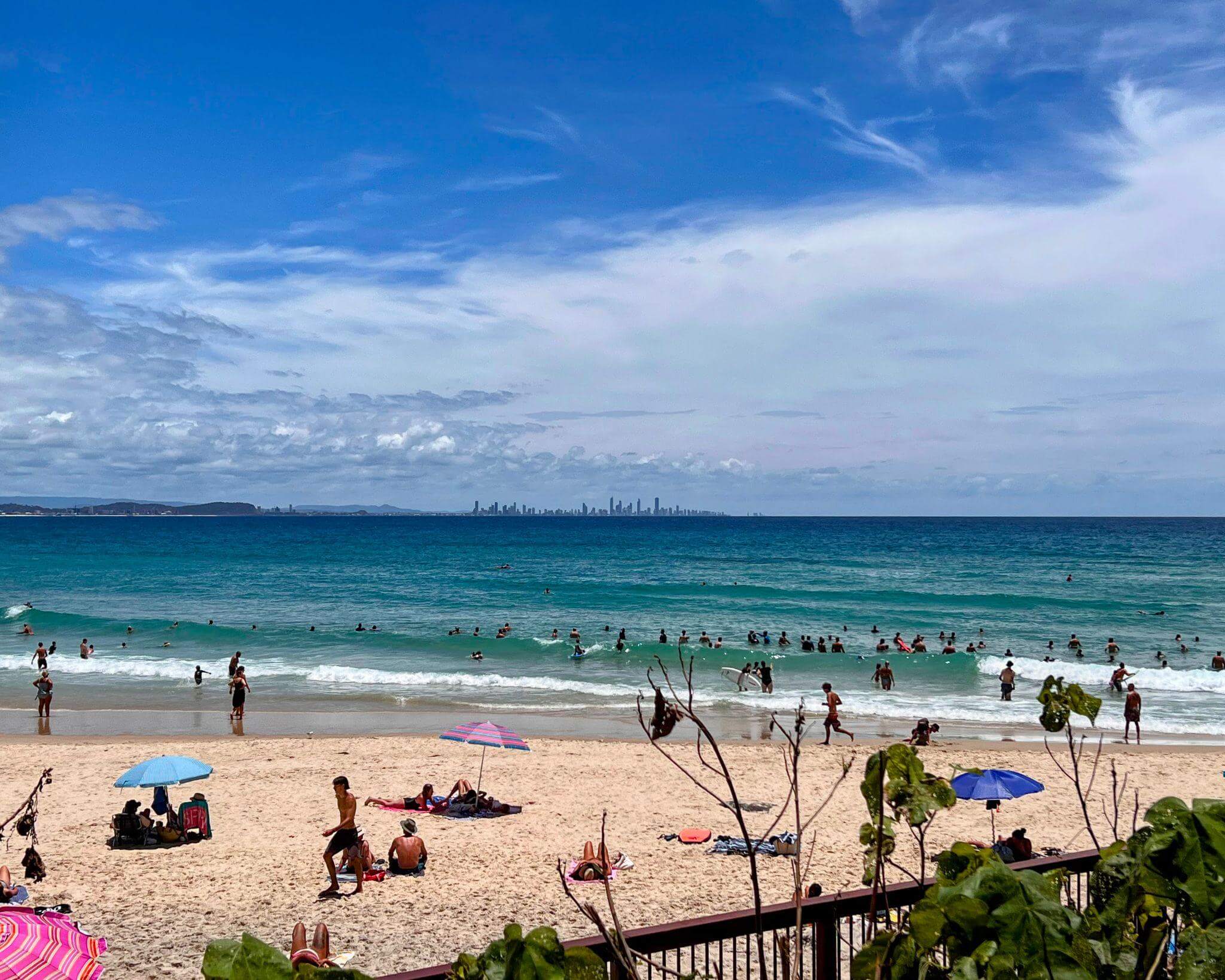 Morning beach walk and swim at the Gold Coast, Queensland, with many people swimming and enjoying the beach
