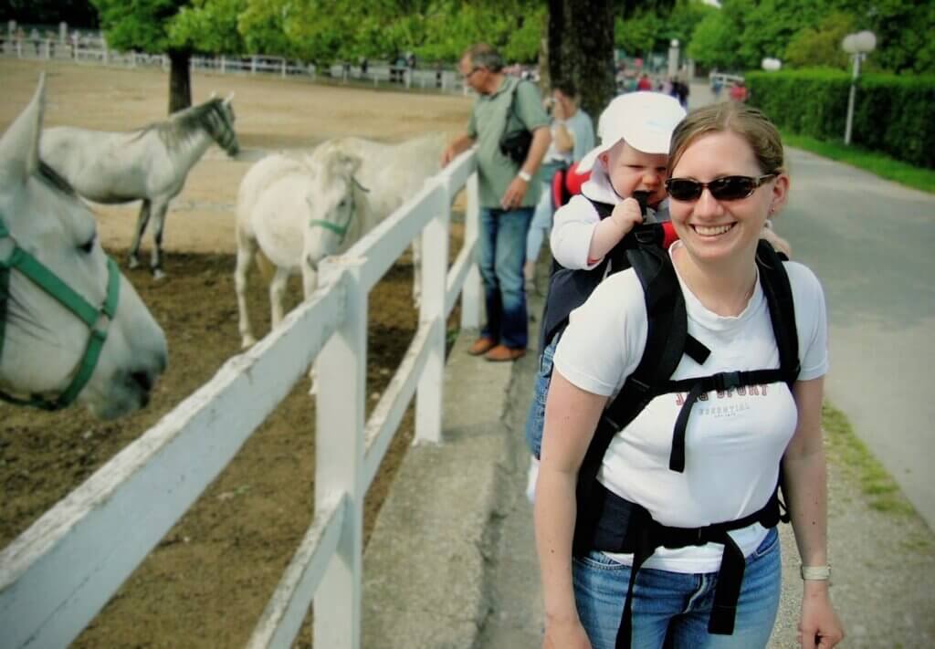 City walking with baby in Vienna to look at horses Rachel Reinke carrying a baby on a day walk in Vienna to look at white horses in a stable