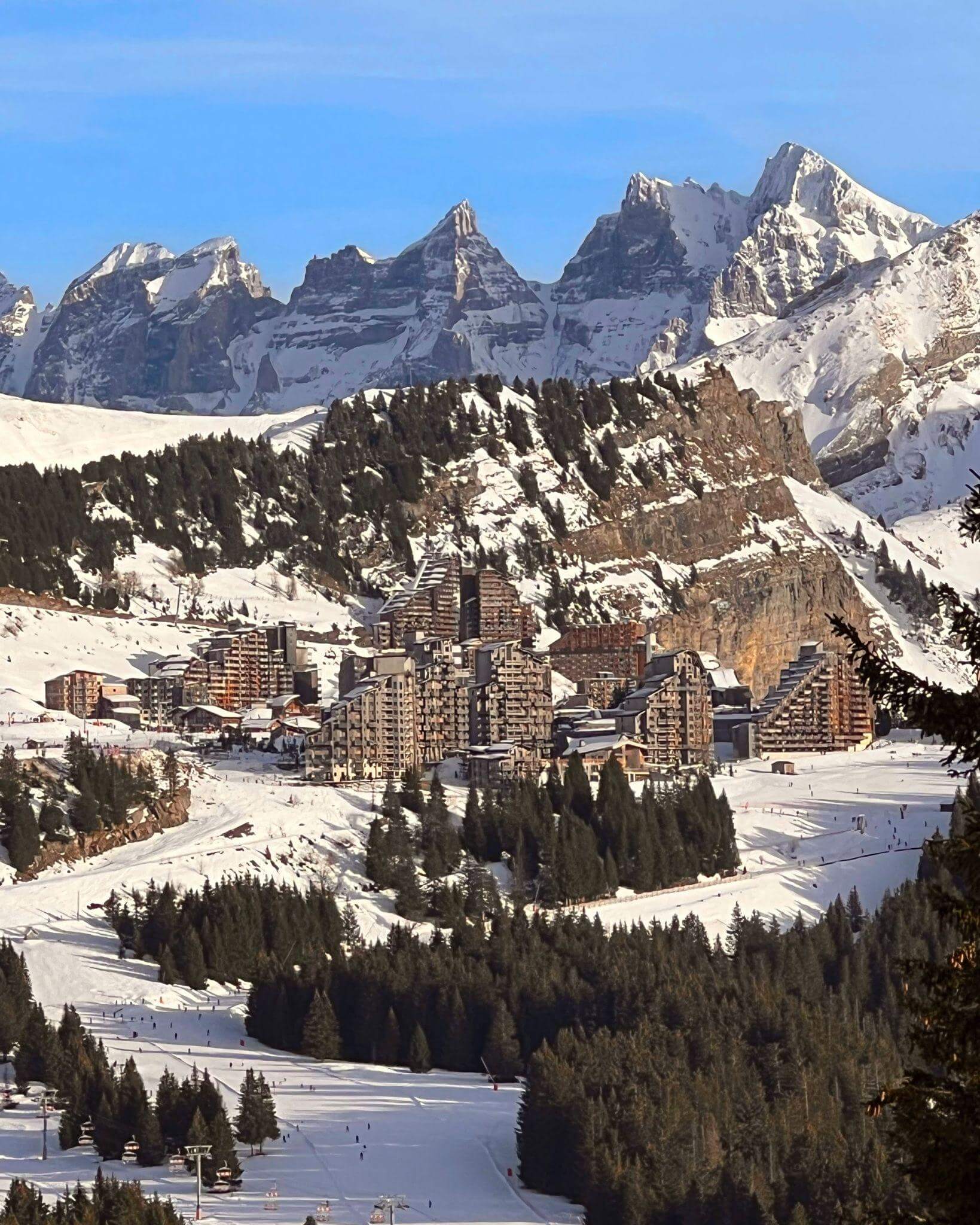 panoramic view of the Avoriaz ski resort in France from the peaks of the alps to the unique buildings and people skiing on the slopes