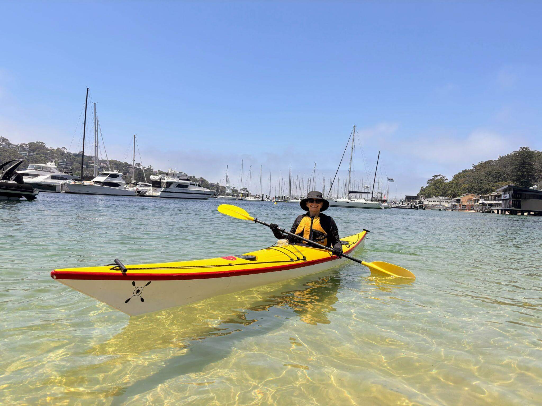Rachel Reinke kayaking in crystal clear waters of sydney harbour, middle harbour, spit bridge