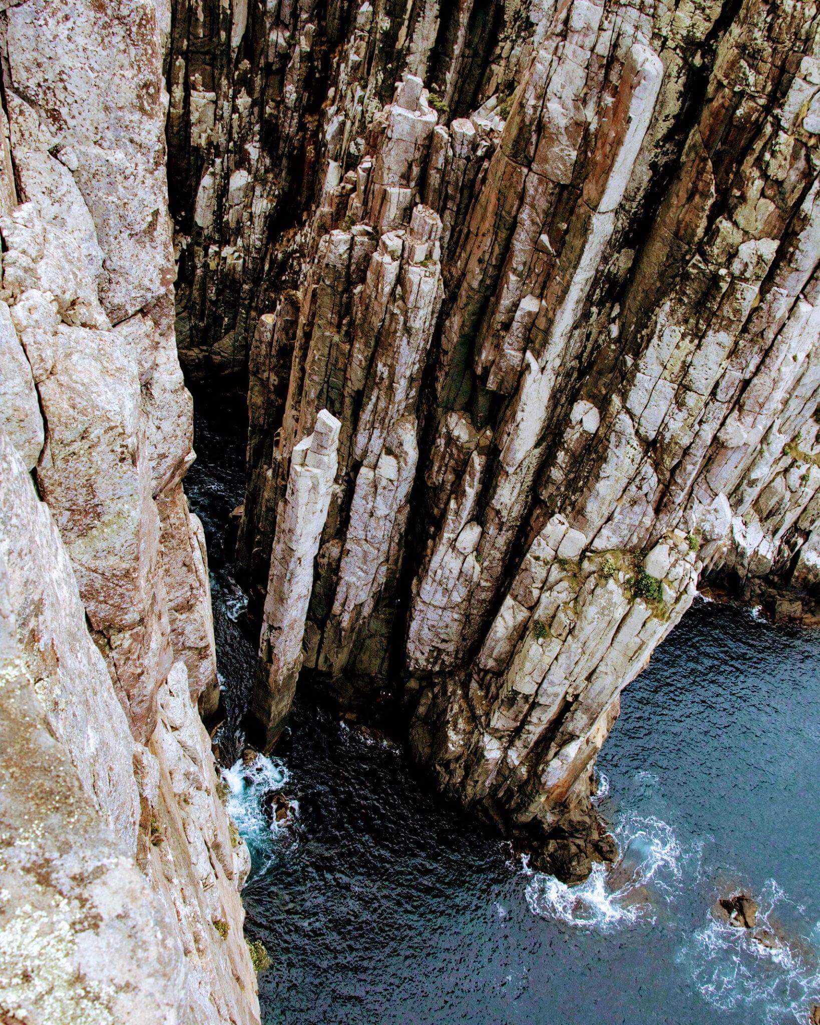 Approaching Cape Hauy showing the dramatic rock formations including the famous Totem Pole sea stack