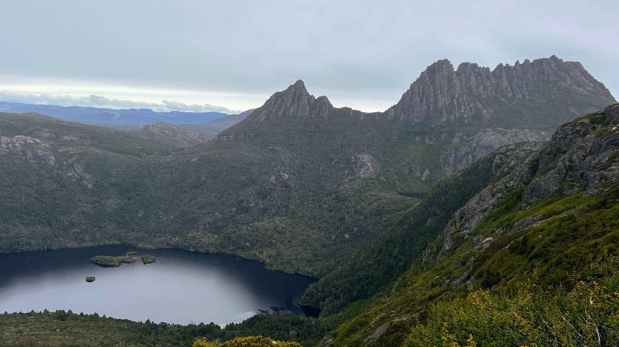 Panoramic view from Cradle Mountain plateau showing Dove Lake below and surrounding wilderness