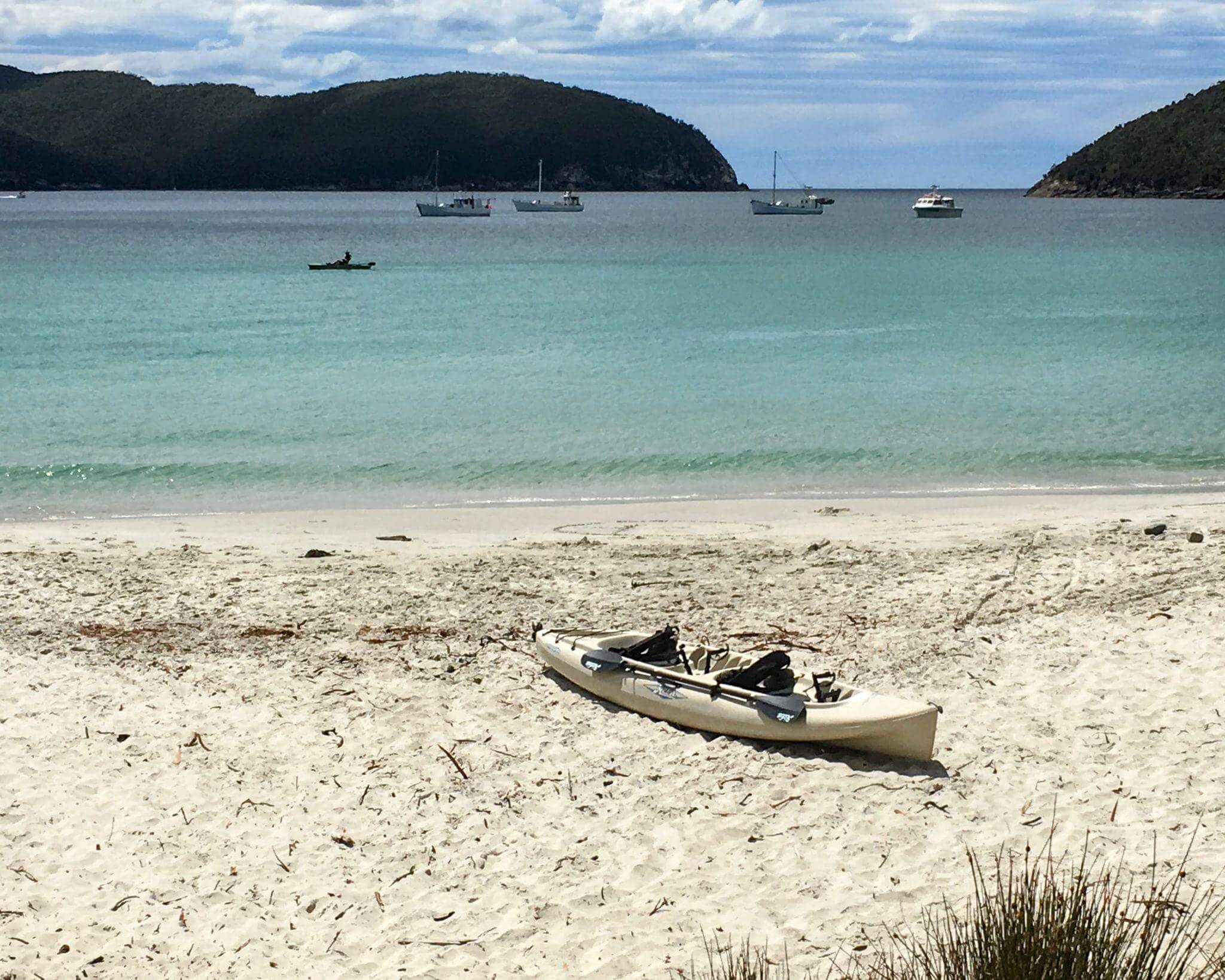 relaxing and celebrating at beautiful Fortescue Bay beach after completing the Three Capes Track