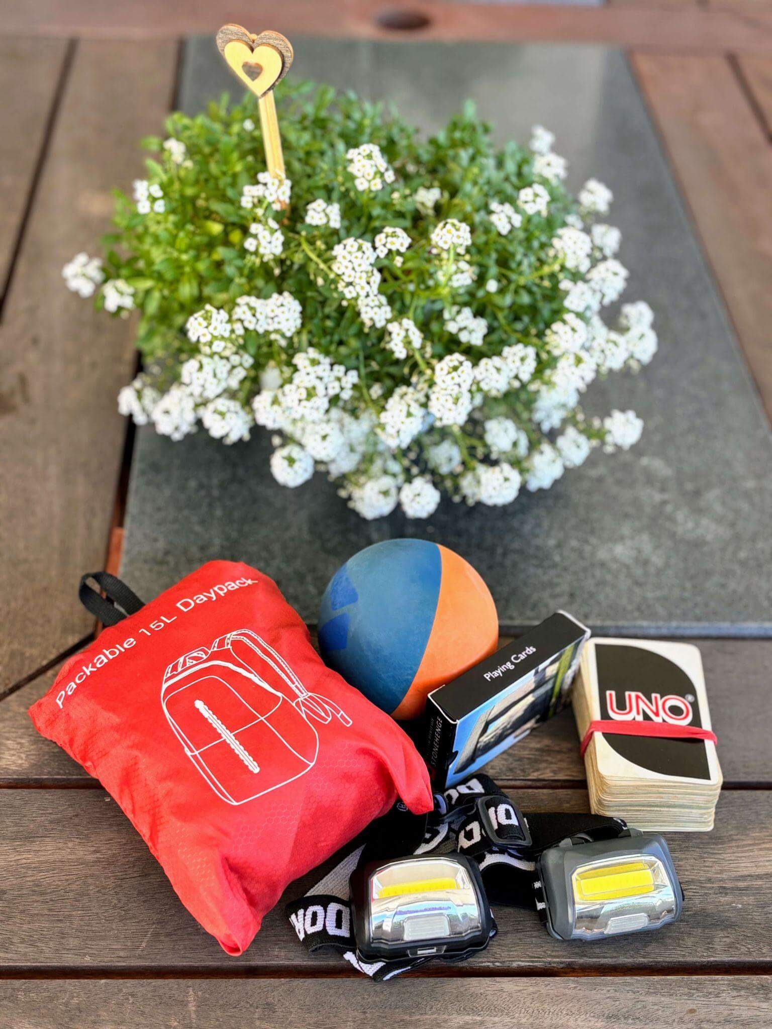 Packable daypack, playing cards, UNO cards, headlamps and safety gear for multi-day mountain hiking adventures