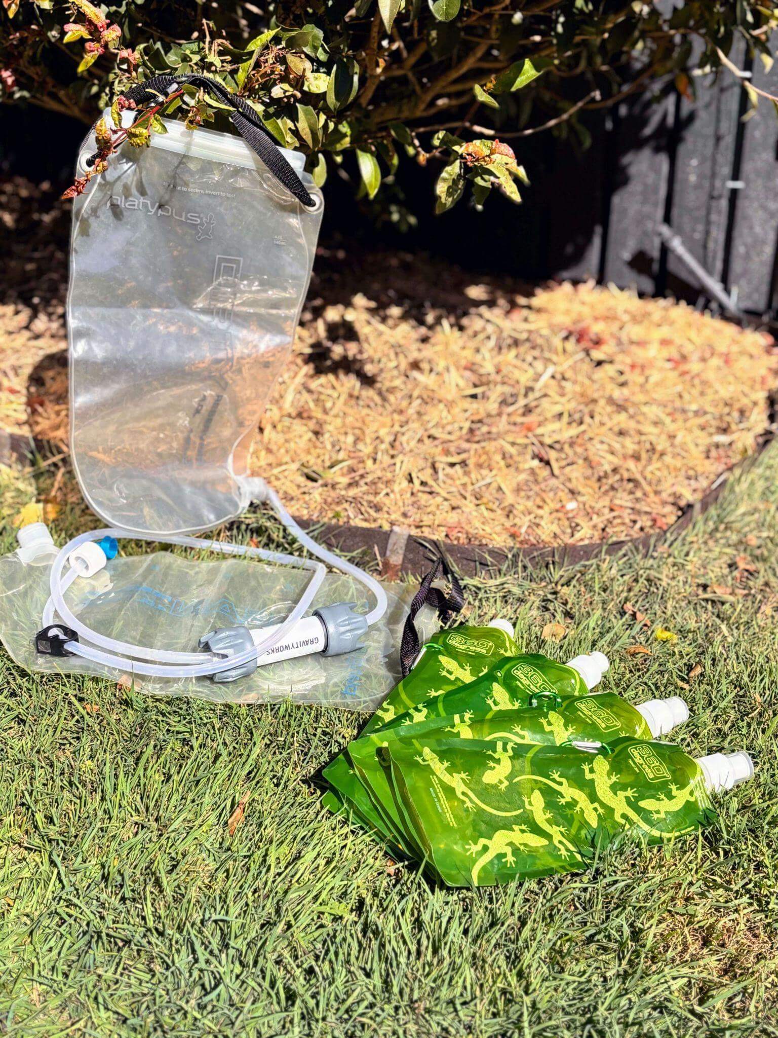Platypus hydration system and water treatment tablets for multi-day hiking, showing essential water purification and hydration gear for wilderness backpacking